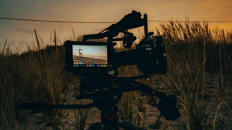 Cinema camera on a tripod at sunset